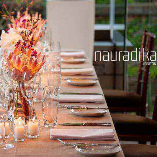 Elegant table set up with floral arrangement and candles, showcasing what makes an elegant table set up.
