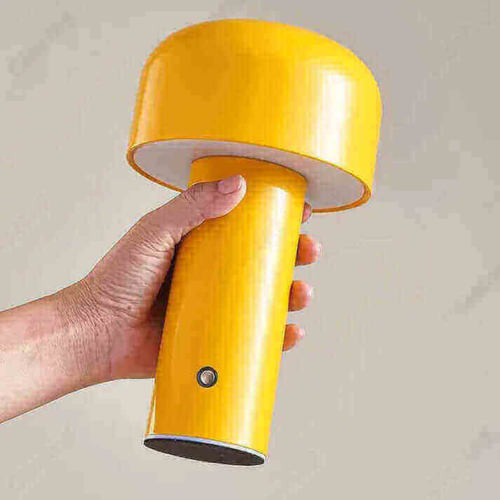 Italian Designer Mushroom Table Lamp in yellow being held in hand