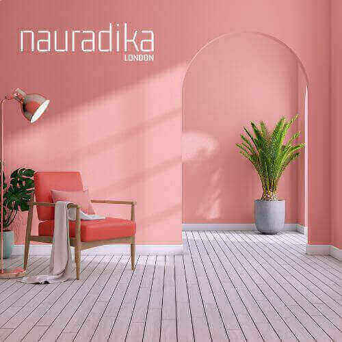 Stylish pink interior design with chair and plant highlighting the Use of Pink in Interior Design.
