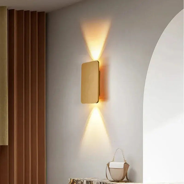 Brushed Gold/Black Double Head Wall Light illuminating a modern interior with elegant up-and-down light beams.
