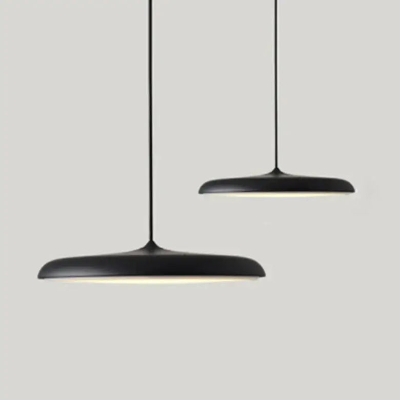 Minimalist Metal Hanging Lamp in black with soft glow, perfect for contemporary home decor.