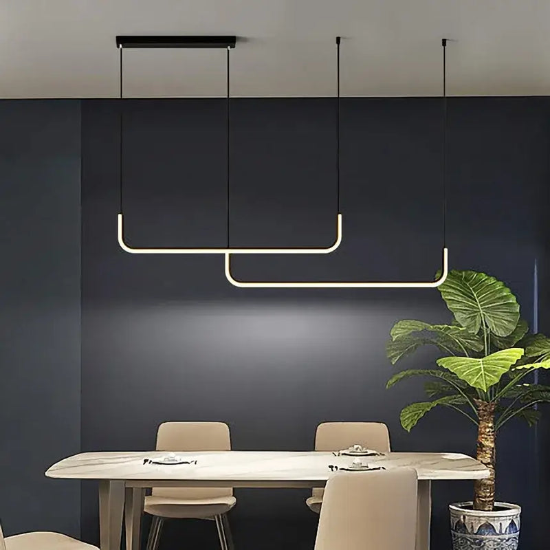 Modern Minimalist Kitchen Island Lighting - Black & Gold Options featuring a sleek design above a dining table.