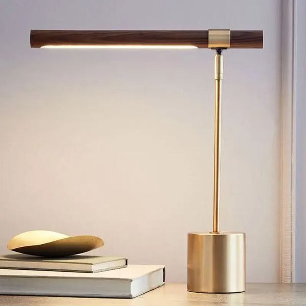 Modern Minimalist LED Table Lamp – Foldable Wood Grain Desk Light with Brass Base on a desk.