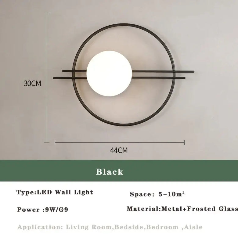 Art Deco Golden Circle Sconce featuring a modern design with a spherical light and black metal finish, ideal for stylish interiors.