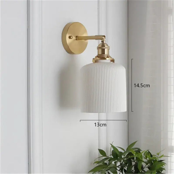 Timeless Elegance: Nordic White Porcelain Wall Lamp displayed on a wall with a gold mount and soft ambient lighting.