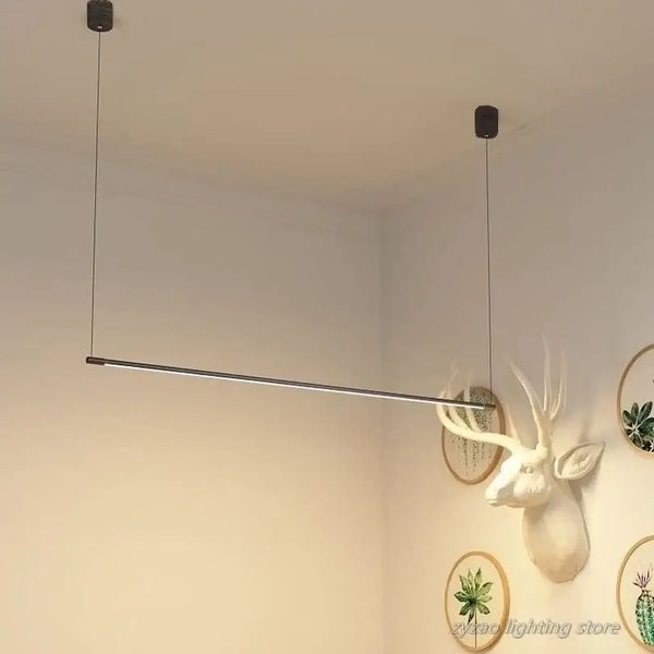 Super Simple Line Lighting | Modern LED Pendant Lamp in minimalist interior setting with mounted wall decor.