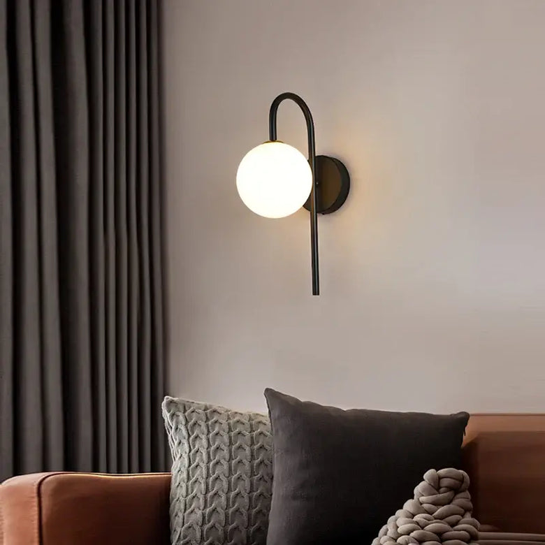 Art Deco Golden Circle Sconce illuminating a modern living room with elegant lighting.
