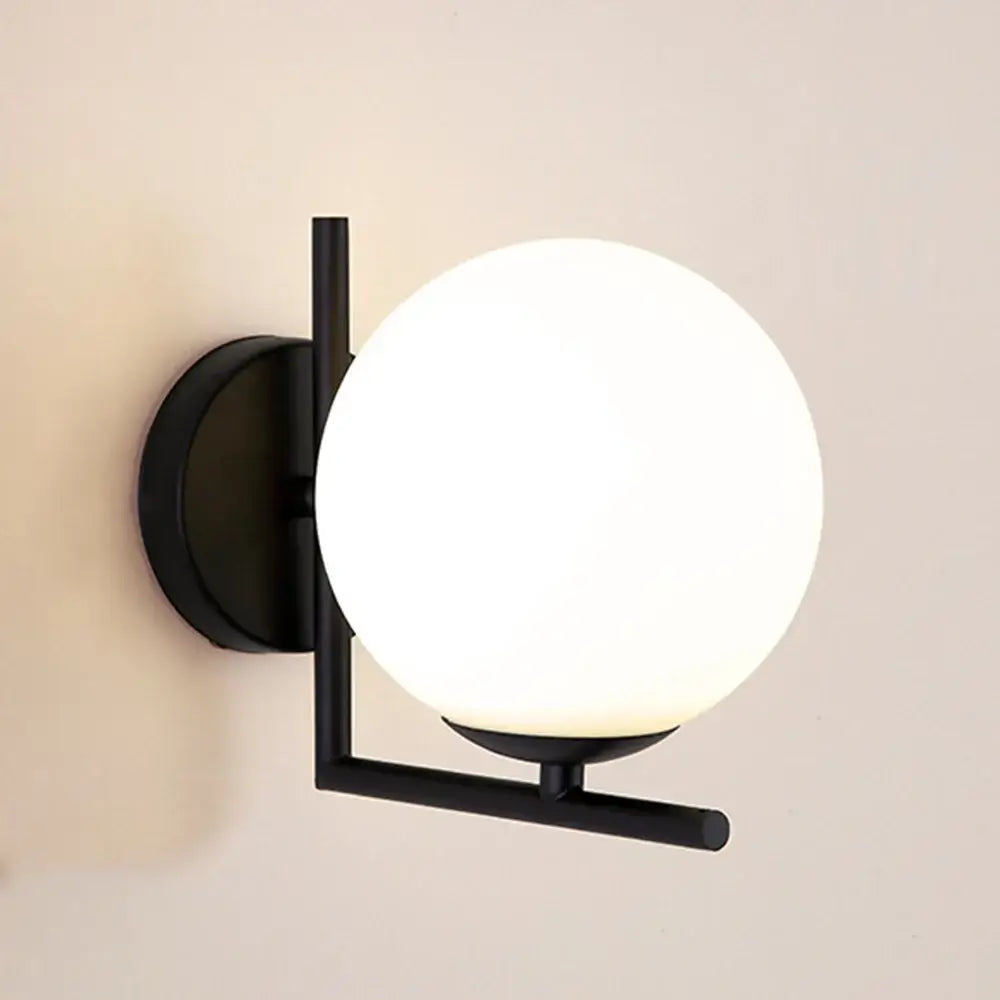 Gold Wall Light with white globe design and black structure, ideal for enhancing modern interior decor in hallways and bathrooms.