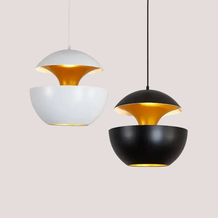 Kitchen Island Scandi Pendants featuring white and black lamps with gold accents for modern lighting decor.