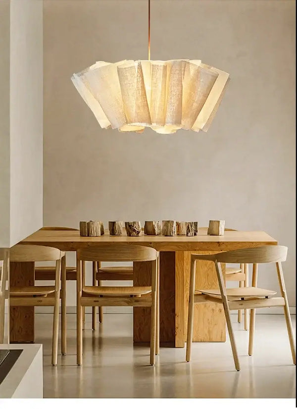 Off-White Pendant Light made from Natural Plant Fiber illuminating a dining space with wooden furniture.