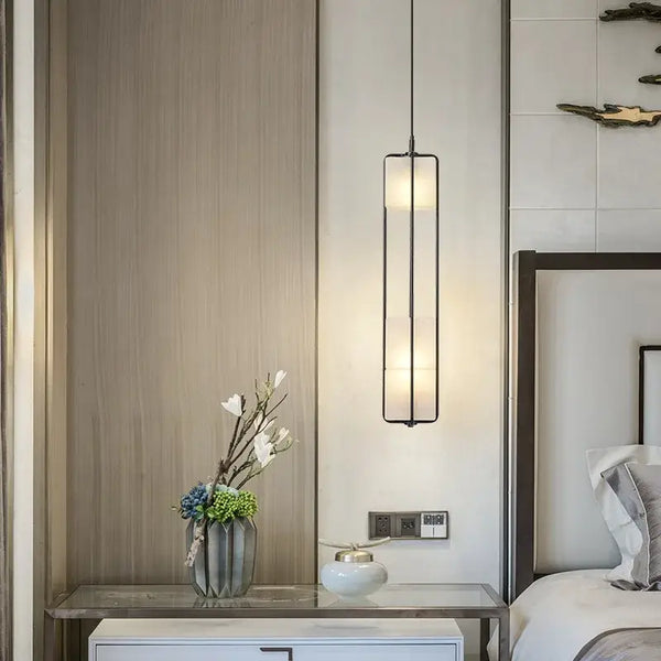 White Glass & Metal Art Deco Chandelier illuminating a stylish bedroom with elegant decor.