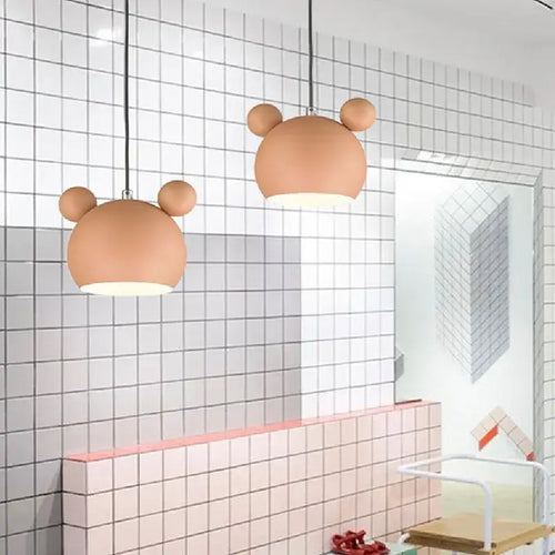 Two Cartoon Mouse Lamp Shades hanging in a modern kitchen with patterned tiles.