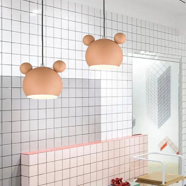 Two Cartoon Mouse Lamp Shades hanging in a modern kitchen with patterned tiles.