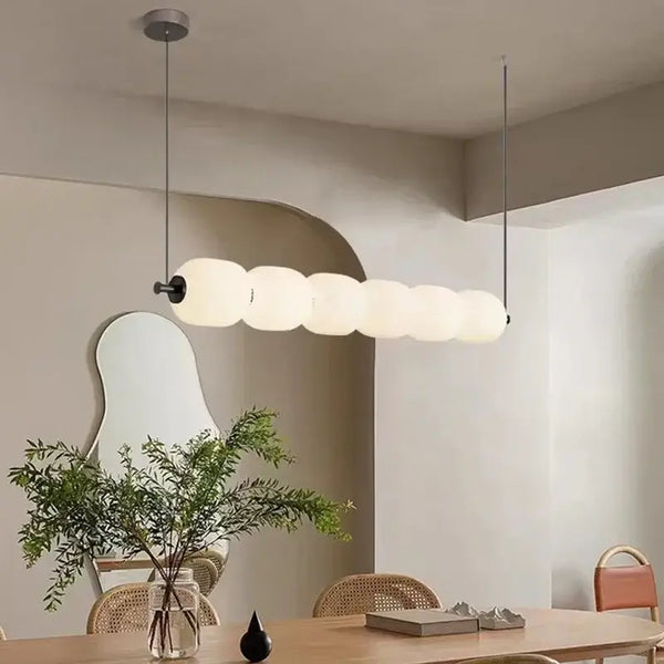 Nordic Art Deco Linear LED Pendant Light – Sculptural Acrylic & Iron Chandelier in a modern dining space.