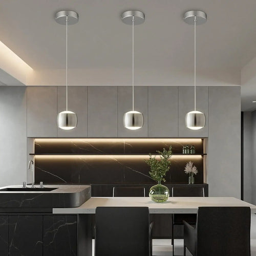 French Nouvelle Vague Pendant Light in modern kitchen setting with sleek black cabinetry and minimalist design.