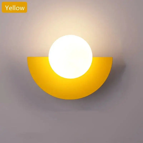 Halfmoon Metal Sconce in yellow color, featuring a round LED light, showcasing Nordic design.