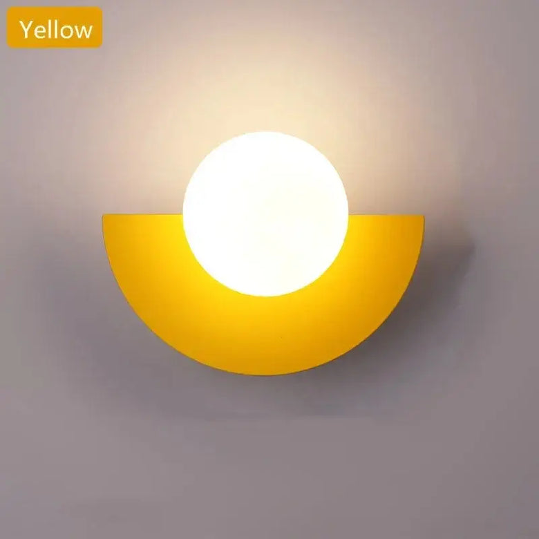 Halfmoon Metal Sconce in yellow color, featuring a round LED light, showcasing Nordic design.