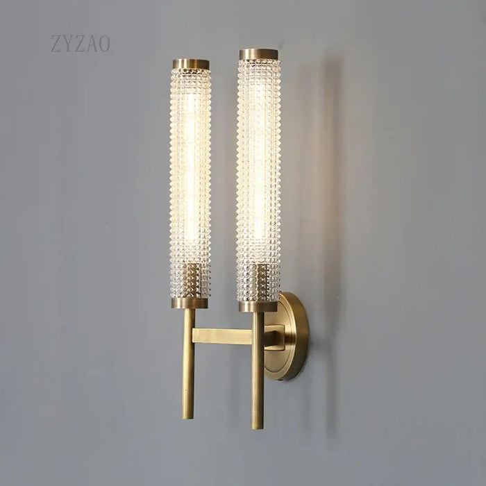 Stylish Art Deco Brass Wall Lamp featuring frosted glass and a warm white glow on a modern wall.