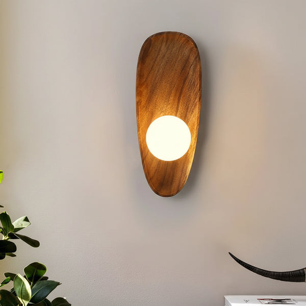 Hero Wooden wall sconce with a light bulb on a plain wall, next to a plant.