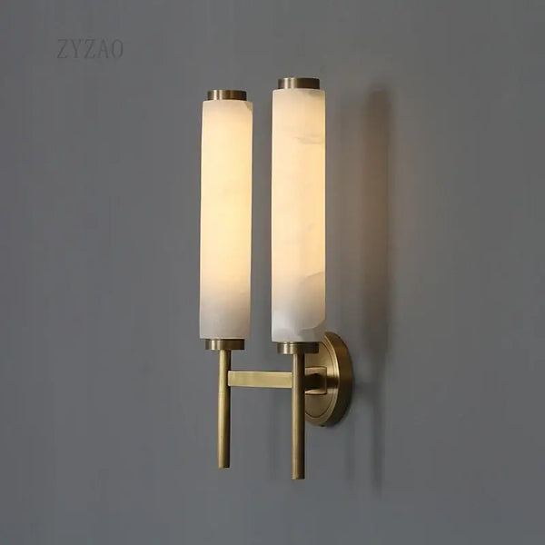 Stylish Art Deco Brass Wall Lamp illuminating a modern space with its frosted glass and brass design.