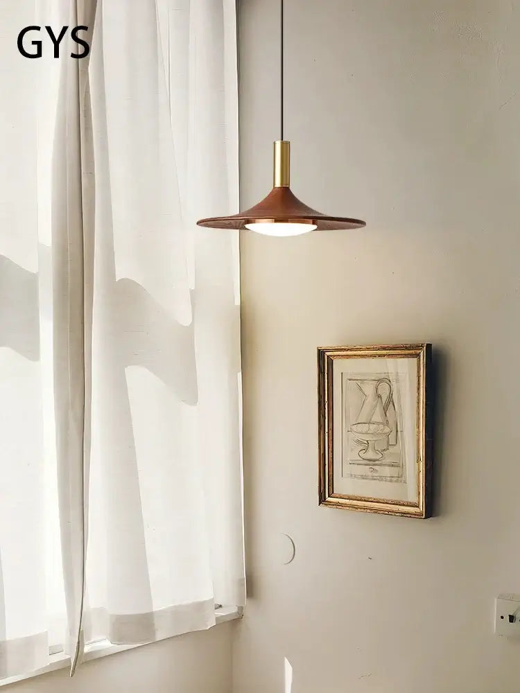 Walnut Mid Century Modern Chandelier illuminating a room with natural light and modern decor.