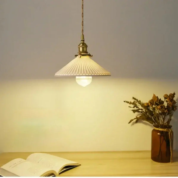 White Ceramic Lamp Shade with Brass Base – Timeless Elegance illuminating a cozy space with stylish decor.