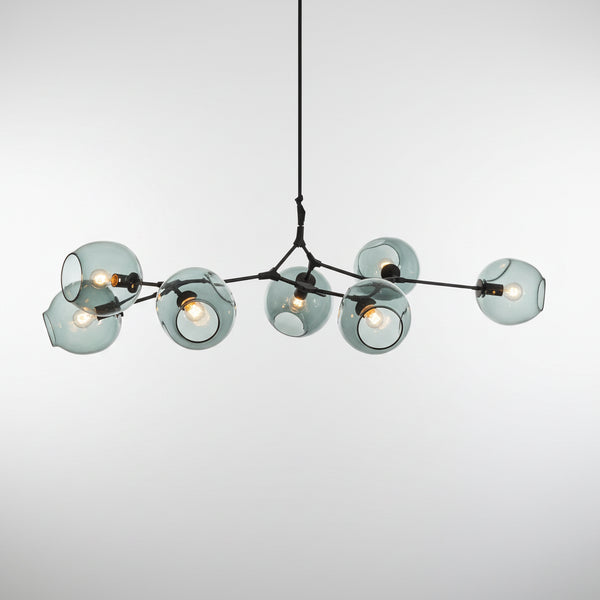hero Modern chandelier hanging above a sofa with abstract wall art in the background