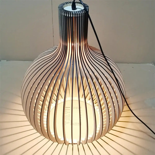 Nordic Retro Modern Wood Cage Pendant illuminating stylishly with wooden slats and cord.
