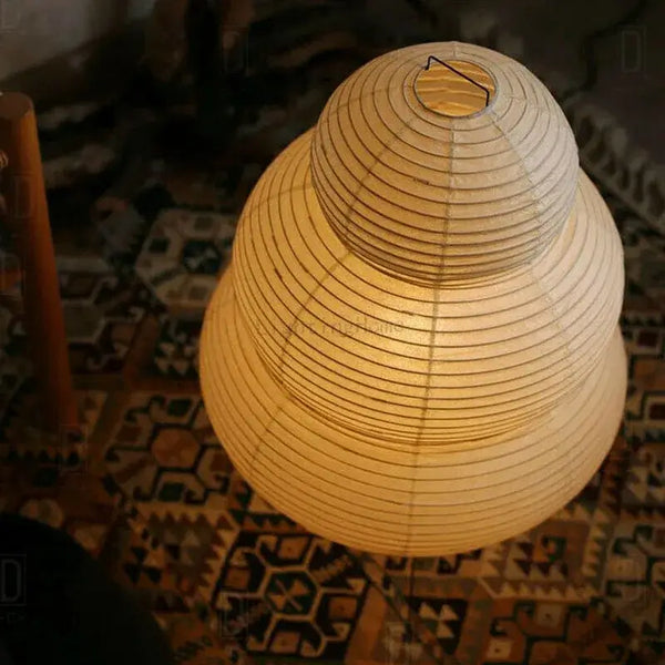 Japanese White Rice Paper Table Lamp showcasing unique design and warm, inviting light in a cozy setting.