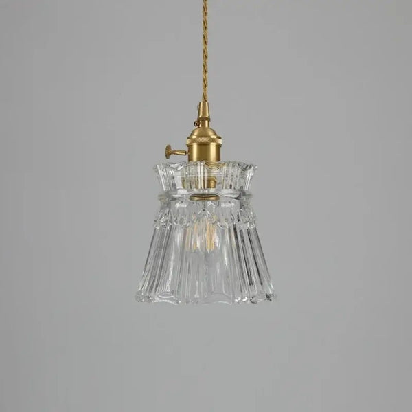 Elegant Glass Pendant Light with Brass Accents - Illuminate with Style showcasing clear glass and brass fixtures.