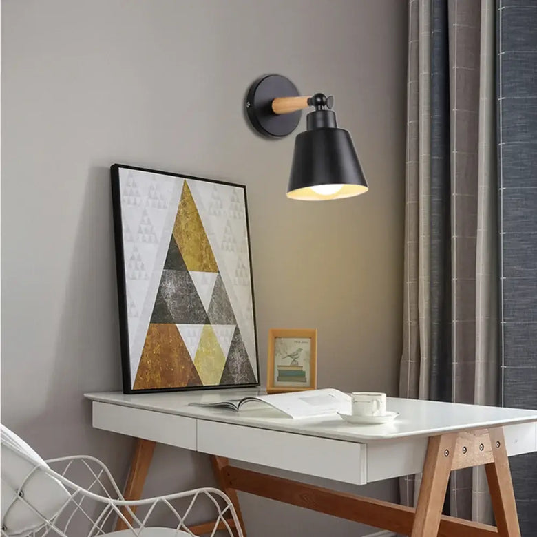 Nordic Solid Wood Bedroom Wall Lamp illuminating a stylish desk with modern decor and a geometric painting.