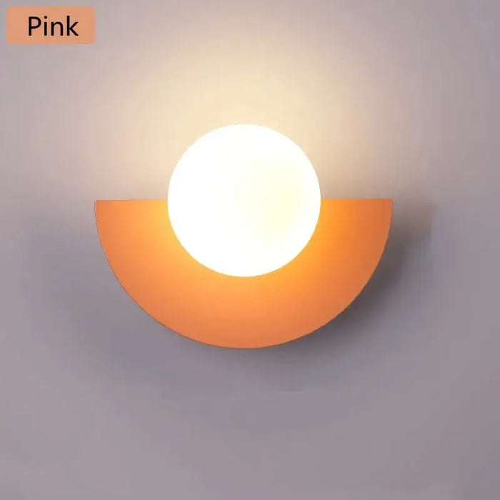 Halfmoon Metal Sconce in pink, modern Nordic design wall lamp with LED light, suitable for various spaces.