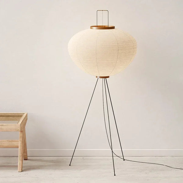 Hero. Japanese Rice Paper Floor lamp with a round paper shade and wooden base in a minimalistic room.