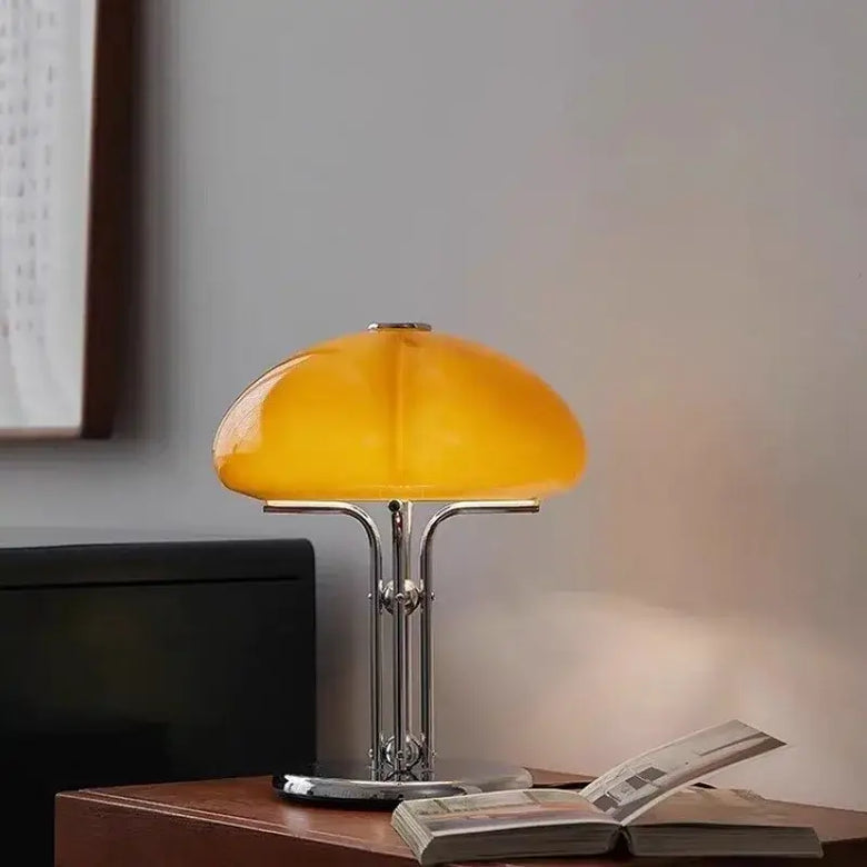 Yellow table lamp on a wooden surface with a blurred background