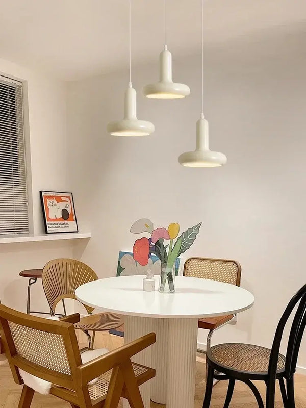 60s Scandinavian Style Kitchen Pendant Lamp hanging above a round white table surrounded by stylish chairs in a modern kitchen.