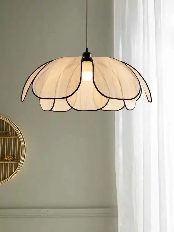 Black and White Rattan Flower Lamp Shade hanging elegantly in a bright room.