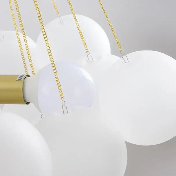 Contemporary Frosted Glass Ball & Gold Chain Chandelier showcasing opulent design with frosted glass balls and golden chains.
