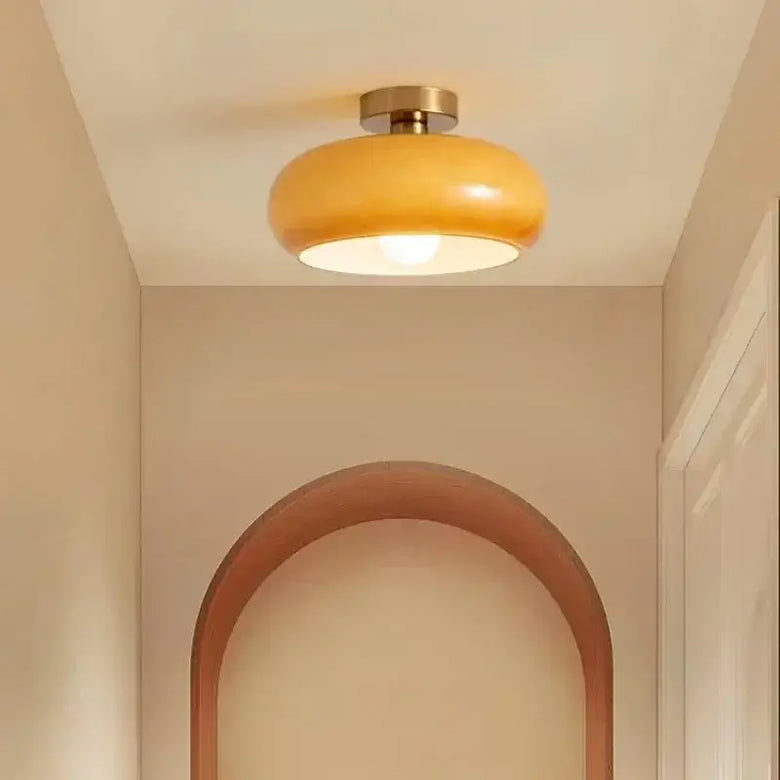 Ceiling light fixture in a room with a wooden archway