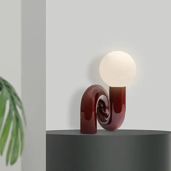 Sculptural Resin Table Lamp – Italian-Inspired Modern Lighting in a stylish setting with a frosted globe.