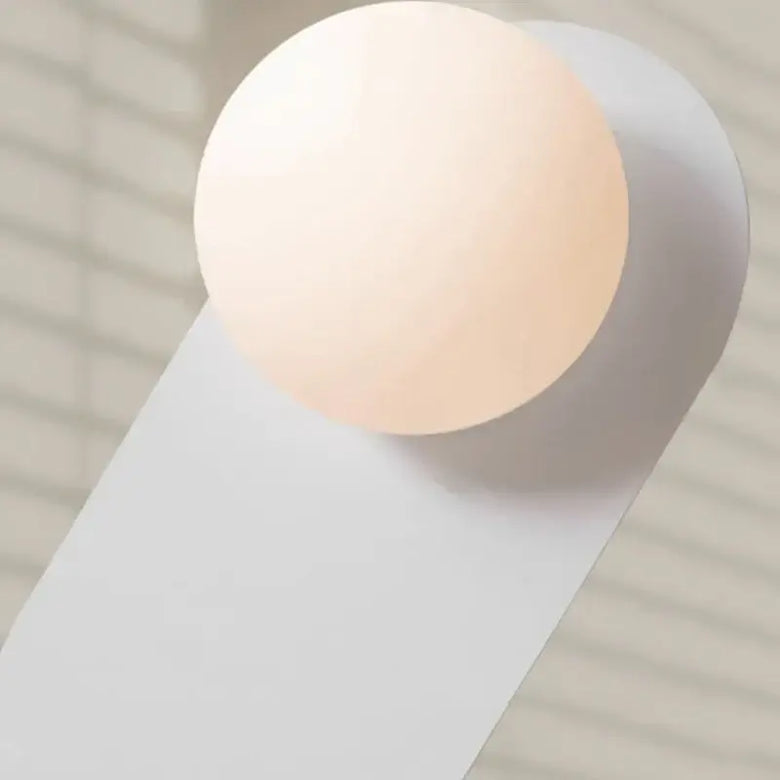 Discover the Vintage Elegance of the 70s-Inspired Metal and Glass Sconce featuring a modern glass orb design.