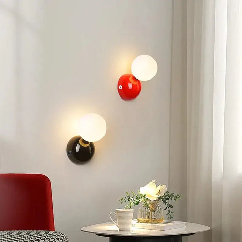 70s revival wall lamp in 3 different colours featuring red, black, and frosted glass designs in a modern living space.