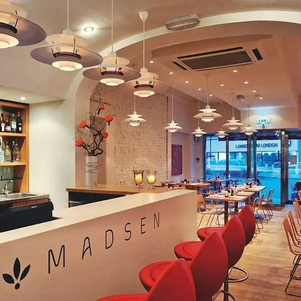 Classic Nordic Designer Pendant Lights Available in 3 different sizes hanging in a modern restaurant interior.