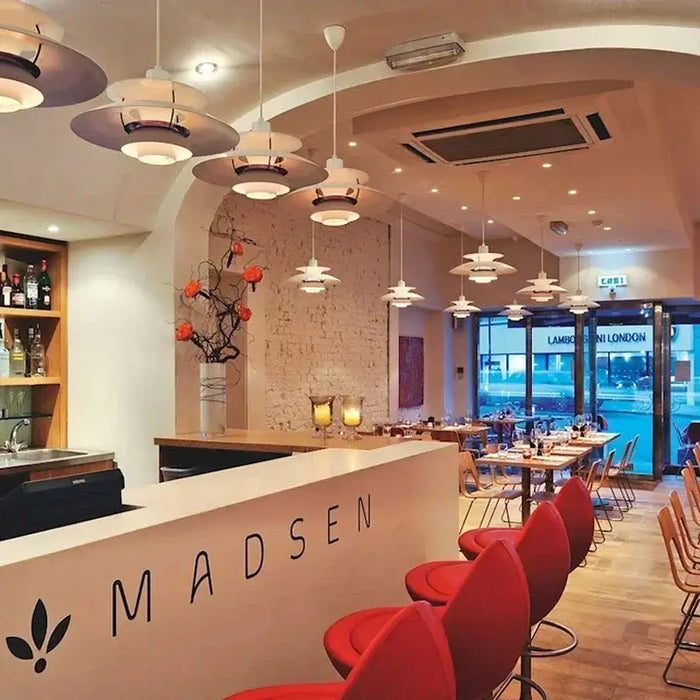 Classic Nordic Designer Pendant Lights Available in 3 different sizes hanging in a modern restaurant interior.