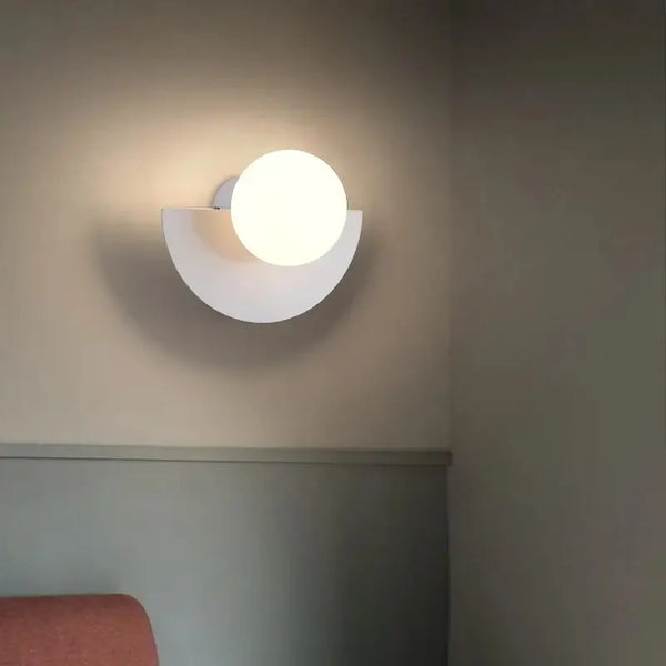 Halfmoon Metal Sconce, stylish wall lamp in Nordic design with round LED light, suitable for various spaces.