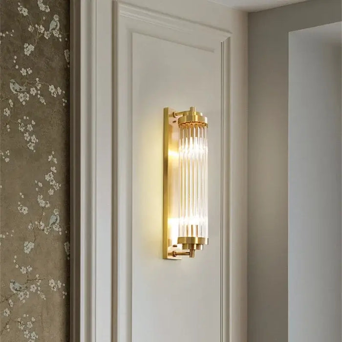 Bathroom Art Deco Brass and Crystal Sconces mounted on a wall, illuminating the elegant design.
