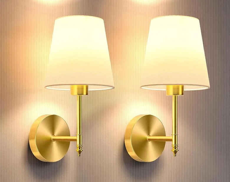 Hero Classic cordless wall sconces, a 2 pack of rechargeable gold-finish lights with white fabric shades on a textured wall
