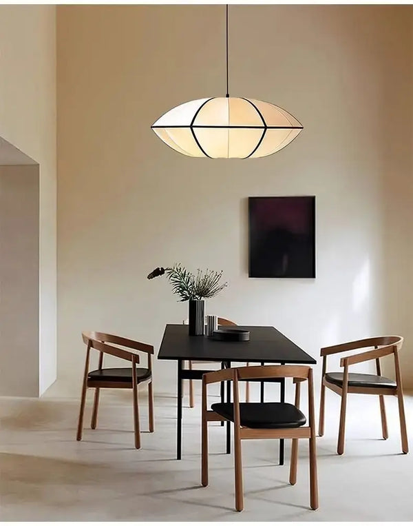 Zen Silk Pendant Light Mid Century Fabric Lantern gracefully illuminating a stylish dining room setting.