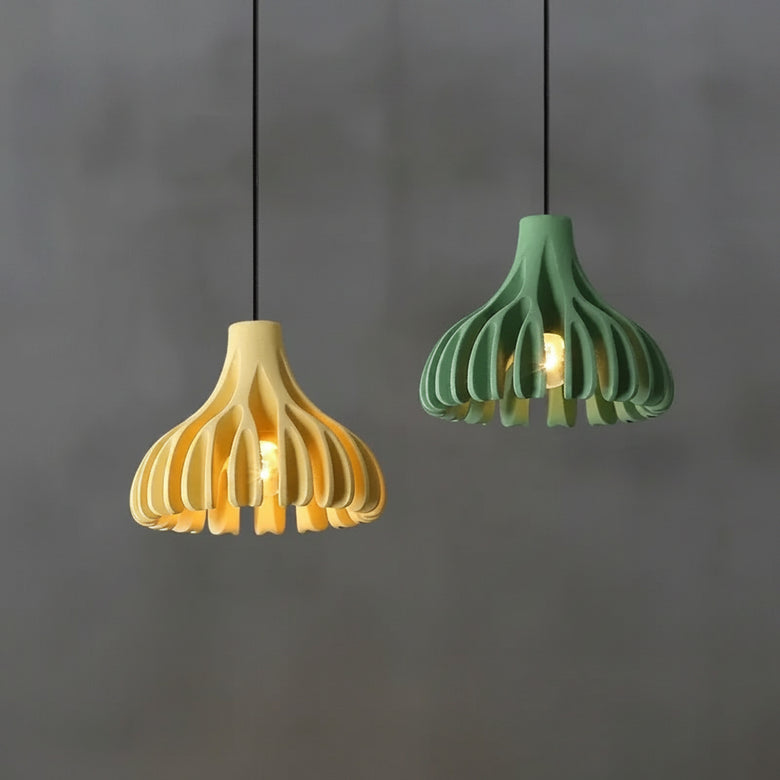 hero Two pendant lights, one yellow and one green, hanging against a gray background.