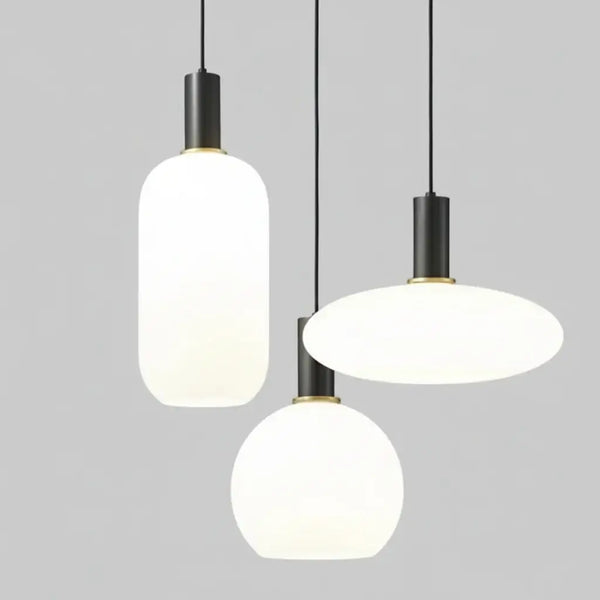 hero Three modern pendant lights hanging against a neutral background