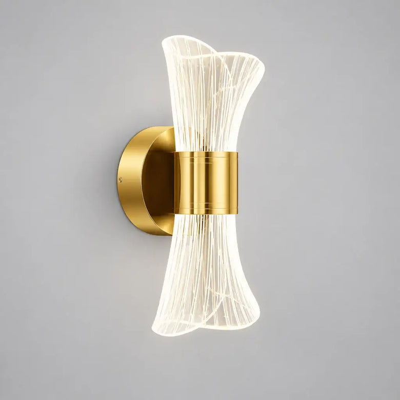 Gold bow LED wall light, modern glam wall sconce, shown in a living room